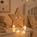 Wooden star-shaped night light with string lights on a shelf in a child's room.