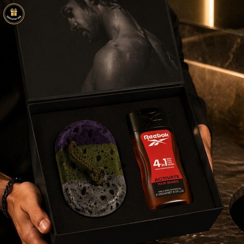 Reebok body care product set in a box held by a person.