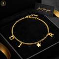 Gold bracelet with letters and a star charm in a black box labeled 'Just for you'.
