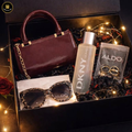 Gift set with a handbag, sunglasses, perfume, and rings in a decorative box.