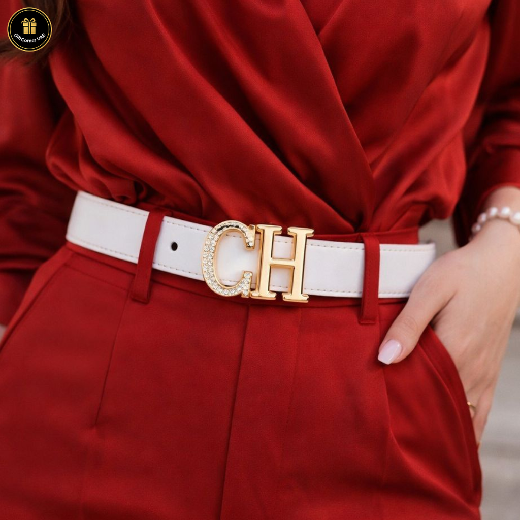 Person wearing a red outfit with a white belt featuring a gold logo.