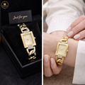 Gold watch with diamond accents in a black box and on a wrist.